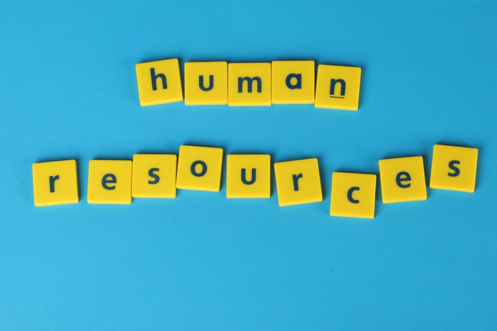 Yellow tiles spelling 'human resources' on a blue background, ideal for HR or business concepts.